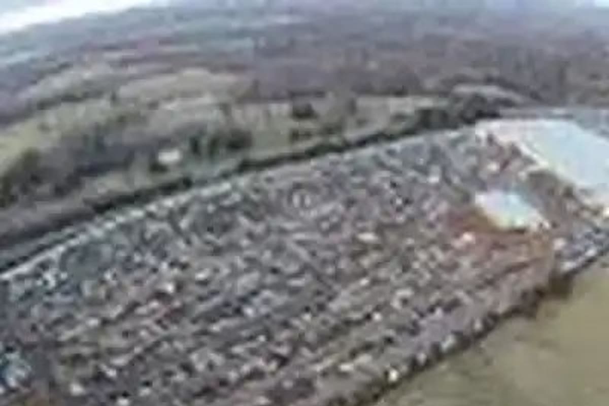 Matlocks Used Cars & Parts: Aerial view of a large salvage yard with dense rows of vehicles beside open fields