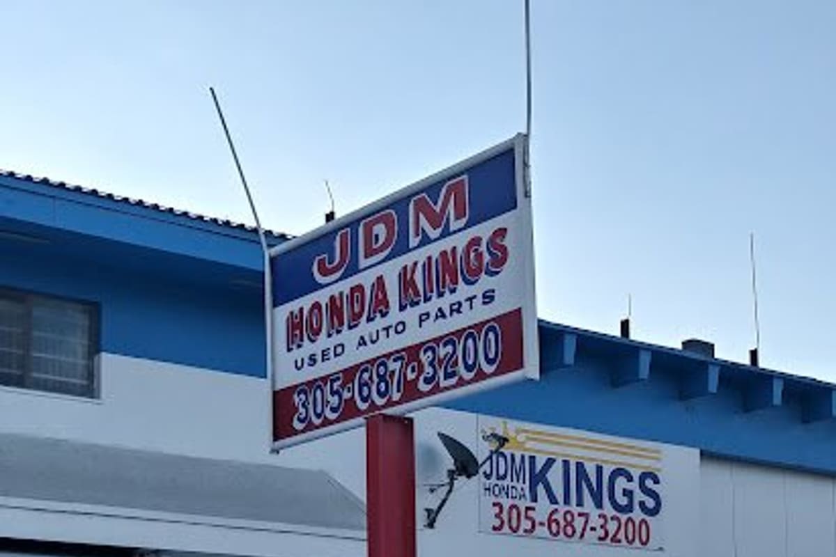 JDM Kings: Pole sign for used Honda auto parts in front of a white and blue building with the street number 13205 on the wall