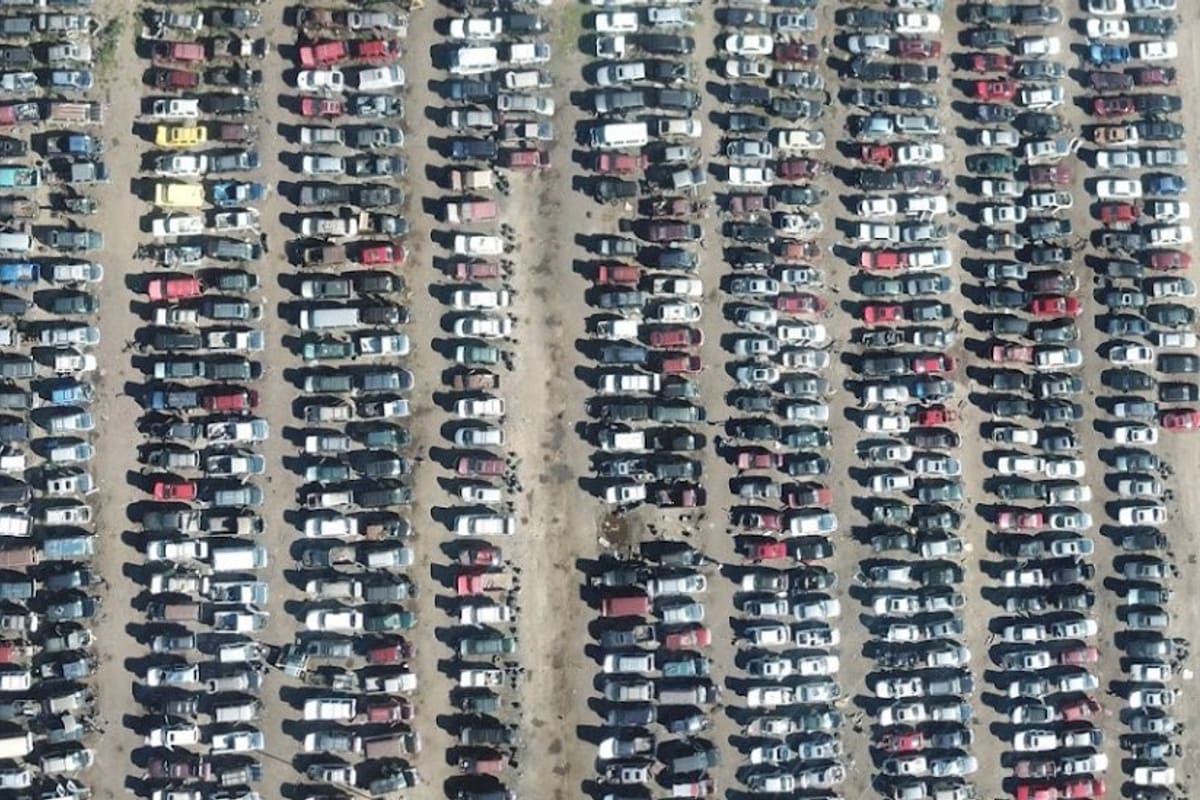 Colorado Auto and Parts: Aerial view of a salvage yard with long rows of cars parked side by side on dirt lanes