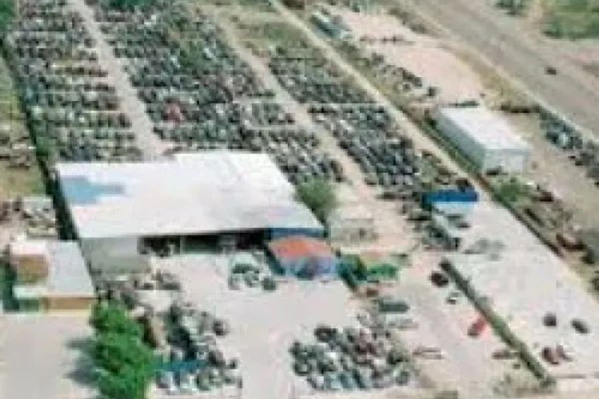 S&O Martinez Auto Parts & Used Auto Sales: Aerial view of a large salvage yard with rows of vehicles beside a warehouse-style building and open lots