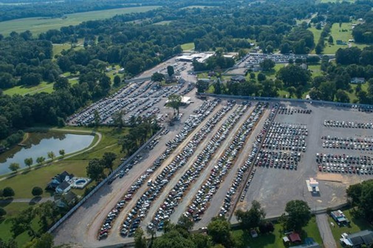 Raceway Pik-A-Part - Savannah, TN: Aerial view of a large salvage yard with long rows of parked vehicles on a gravel lot surrounded by trees and fields