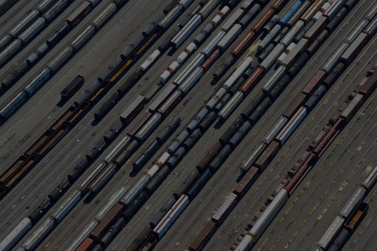Progress Rail: Aerial view of a rail yard with long rows of freight cars and tank cars on parallel tracks