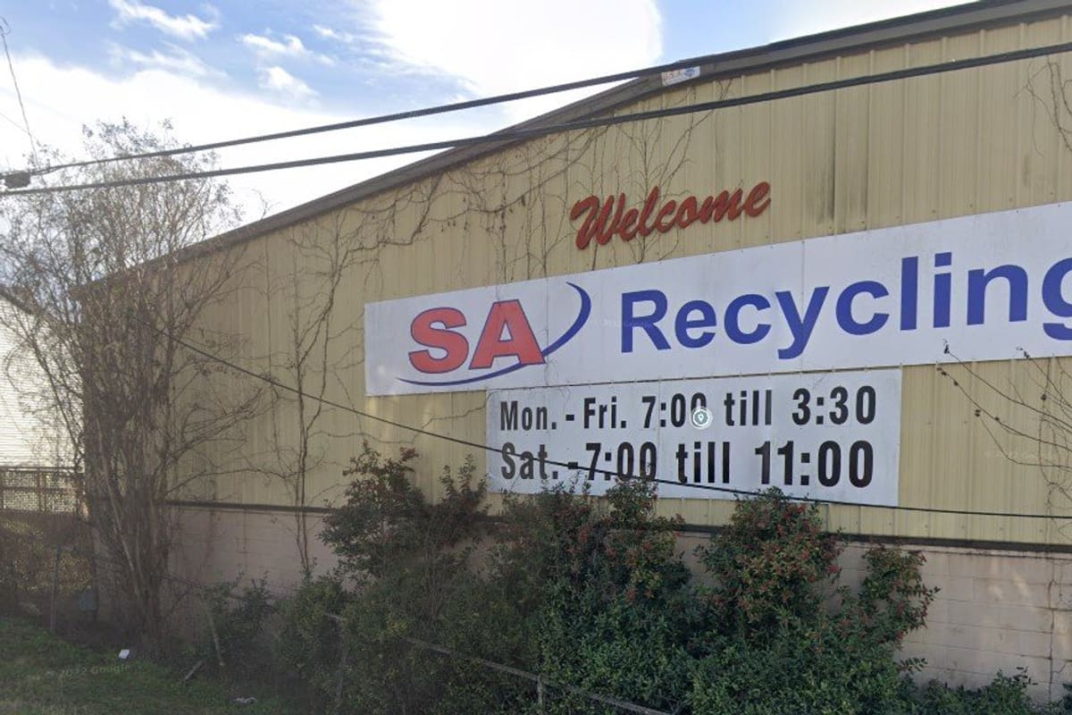 SA Recycling: Metal warehouse building with a large welcome and recycling sign listing weekday and Saturday hours