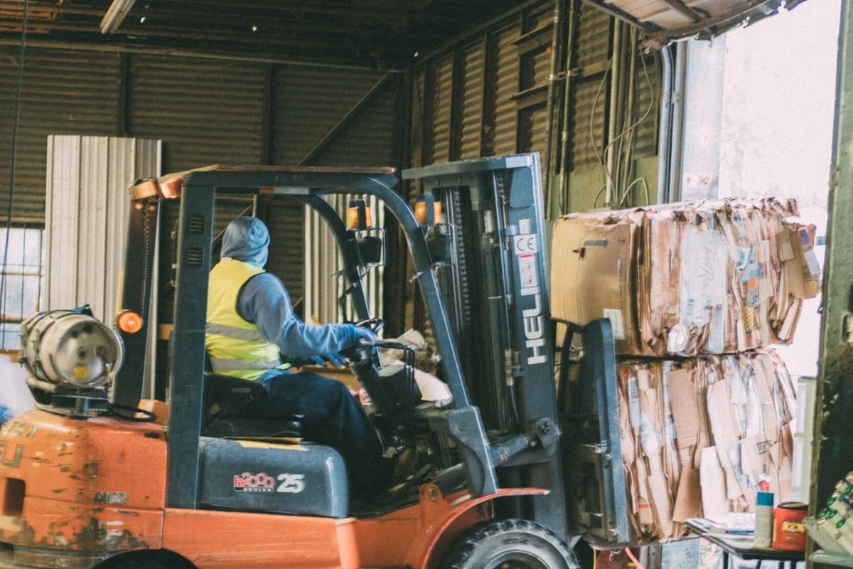 Recycle Revolution: Forklift moving baled cardboard inside a recycling warehouse