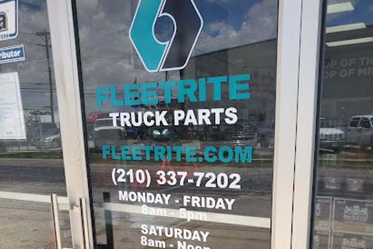 Fleetrite Truck Parts: Glass entrance door with truck parts decal, phone number and business hours listed