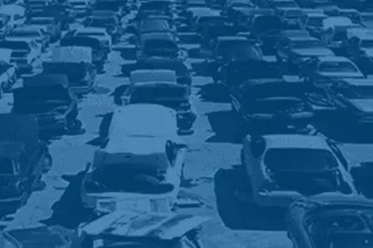 Pick Your Part - Chattanooga: Aerial view of long rows of junked cars parked closely together in a salvage yard, tinted blue