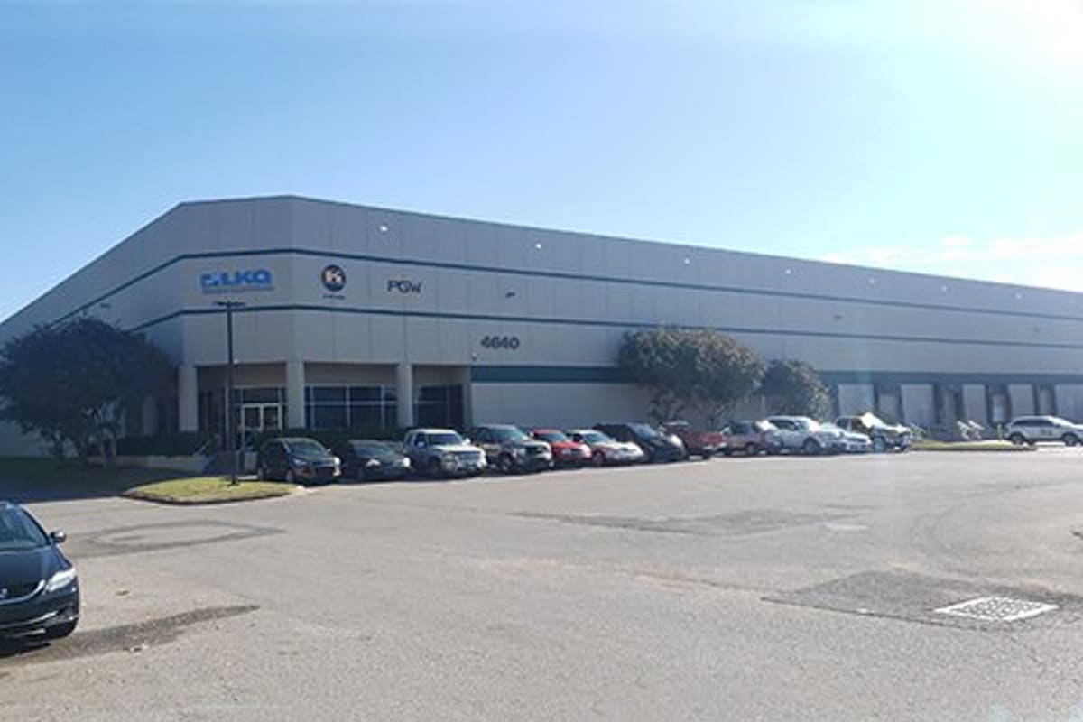 LKQ Memphis: Large gray warehouse building with address number 4640, trees, and cars parked along the front lot