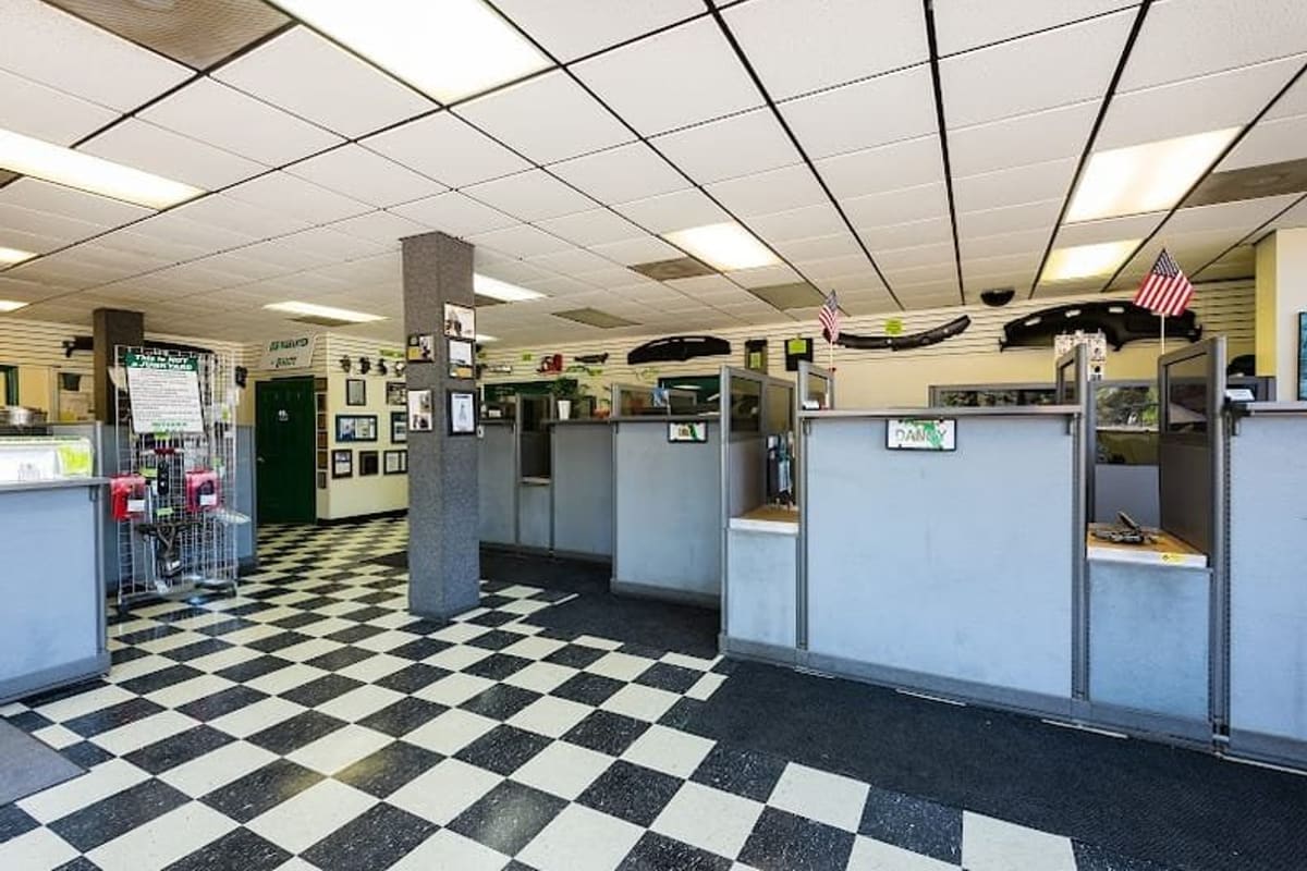 Butler Auto Recycling: Interior of an auto parts sales counter with checkered floor, cubicle service desks and car parts displayed on the walls