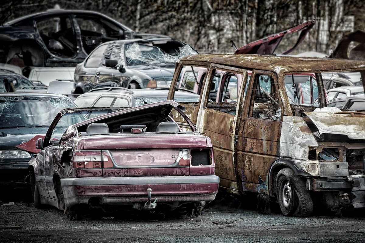 SA Recycling: Rows of wrecked and rusted cars and vans piled together in a salvage yard