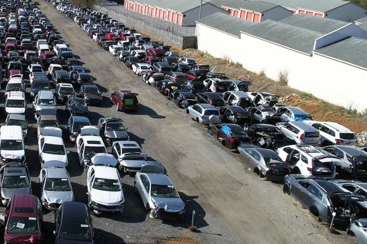 High Point Auto Salvage: Aerial view of a salvage yard with many rows of wrecked and used cars parked on a gravel lot